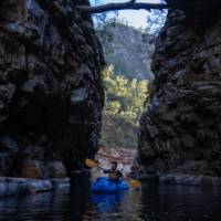 Packrafting through a narrow section of Alum Cliffs Gorge